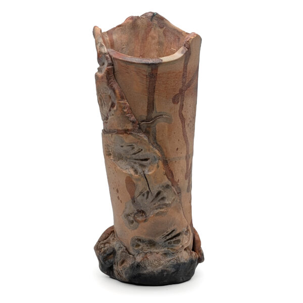 Cylindrical sculpture. The piece is shades of beige and yellow, wrapped with jagged layers of ceramic and abstract blue ceramic shapes.