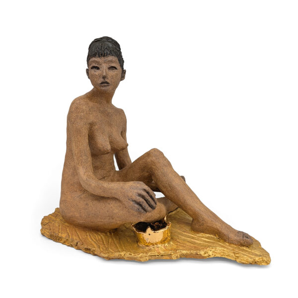 Seated figure of a nude woman, looking slightly off to one side. A gold crown sits next to her.