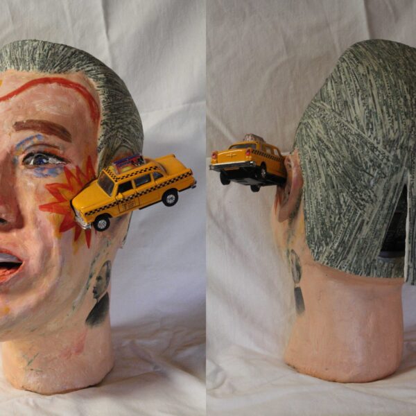 Image showing a bust. The head is a man with gray hair. A yellow taxicab has drawn a red roadmap across his face and appears to be crashing into the side of his head.