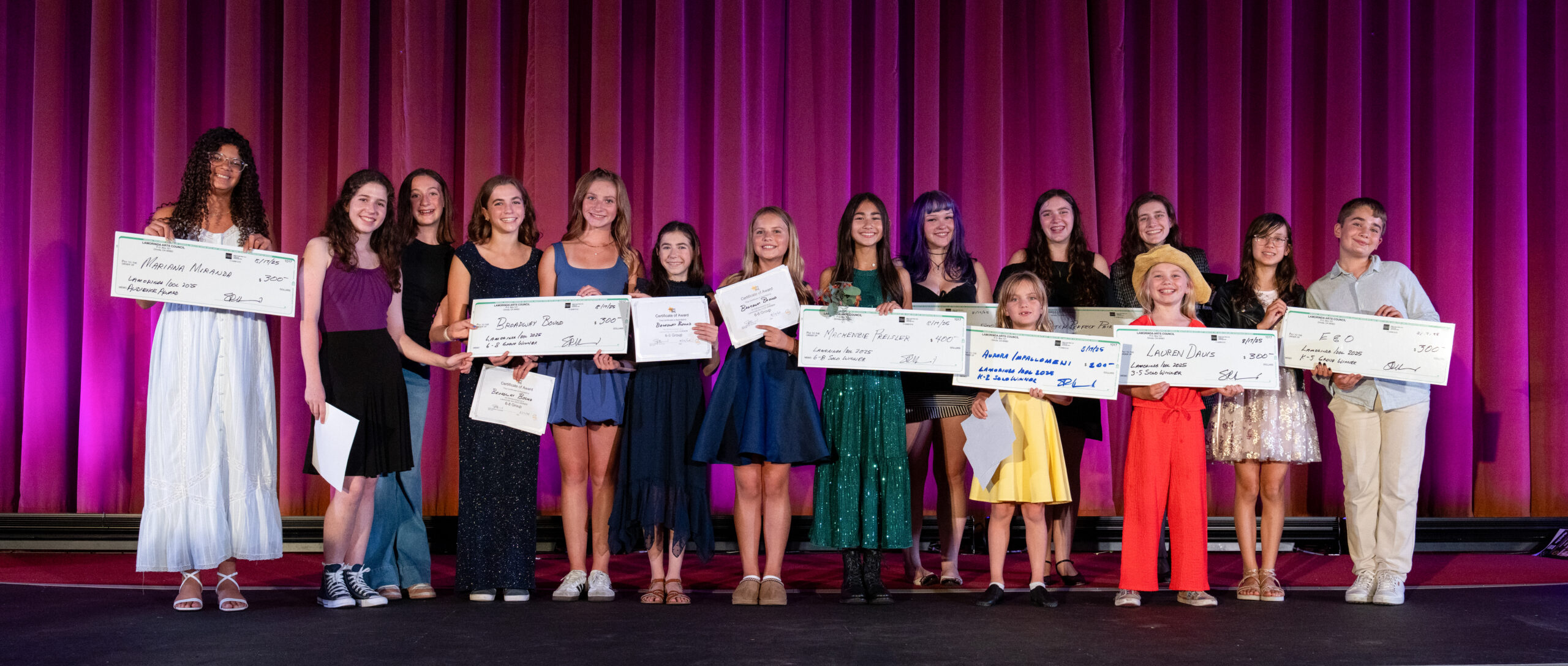 Photo shows Lamorinda Idol winners on stage holding oversized checks