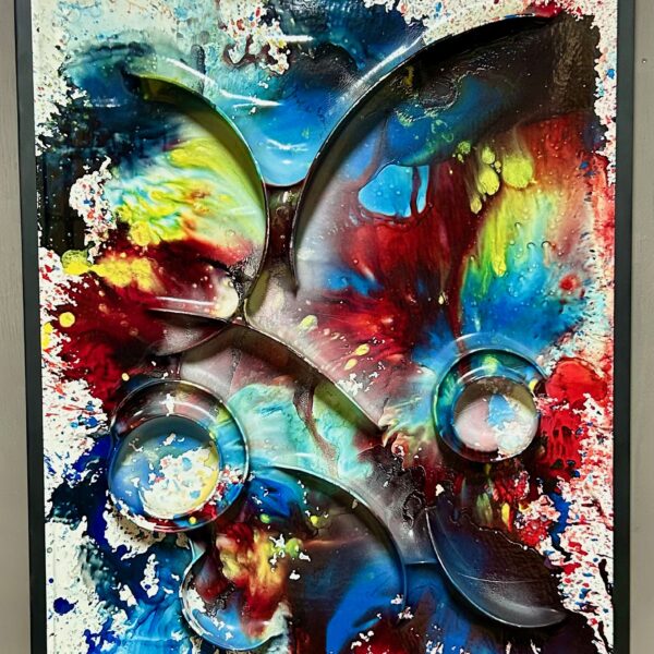 Image shows an abstract painting with brightly colored paint across the canvas.