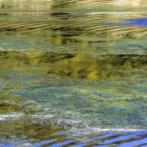 Photograph showing body of water in golden and blue tones.