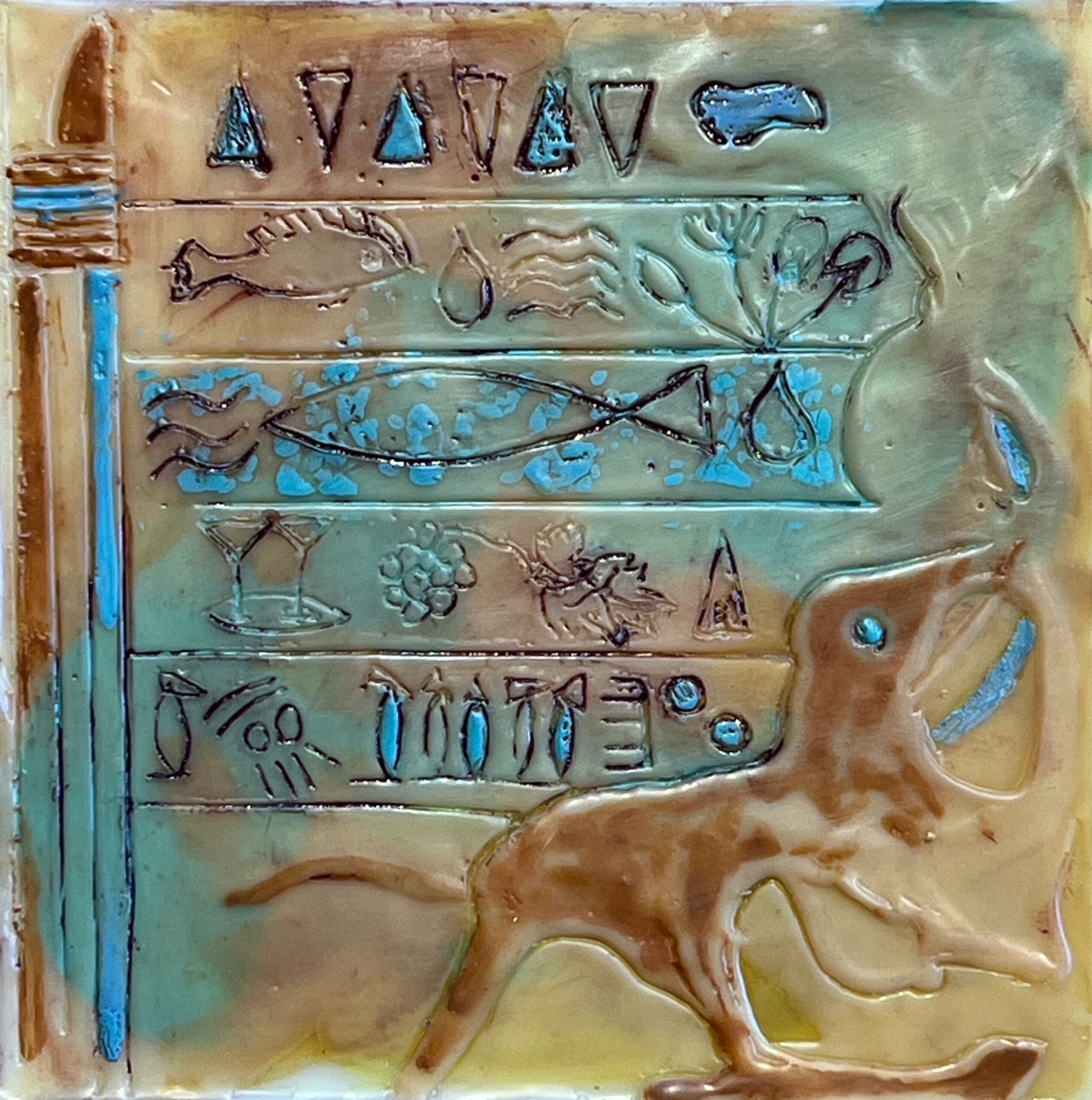 Image shows bluish-brown tablet inscribed with characters and animal shape in the syle of ancient cuneiform tablets.