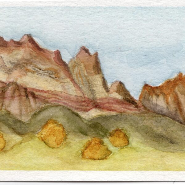 Image shows jagged mountains against a blue sky