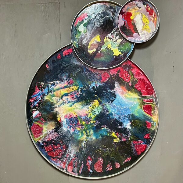 Images shows 3 interlocking circles painted with abstract hues