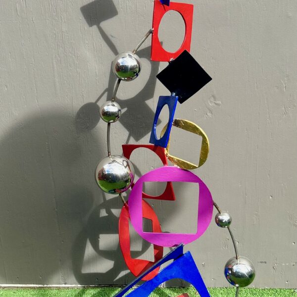 Image shows sculpture of interconnected rings and balls