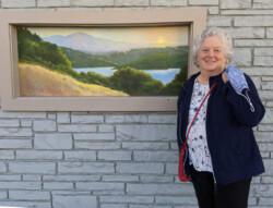 Judith Feins with "Sunrise from Rim Trail", 20" x 50" acrylic painting