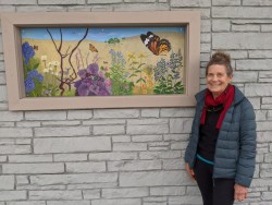 Kath Balamuth with "Raindrops on Monarchs and Masks on Raccoons, Bright Colored Wildflowers and Warm Afternoons", 20" x 50" acrylic painting