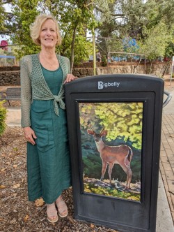 Ruth Stanton stands beside her oil painting of a young buck, located at the entrance to the Orinda Community Center